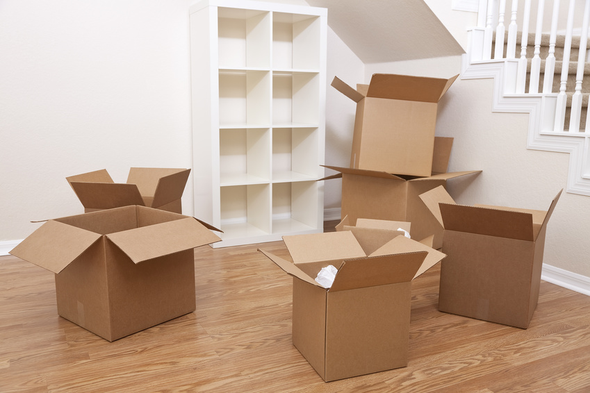 Empty room full of cardboard boxes for moving into a new home.