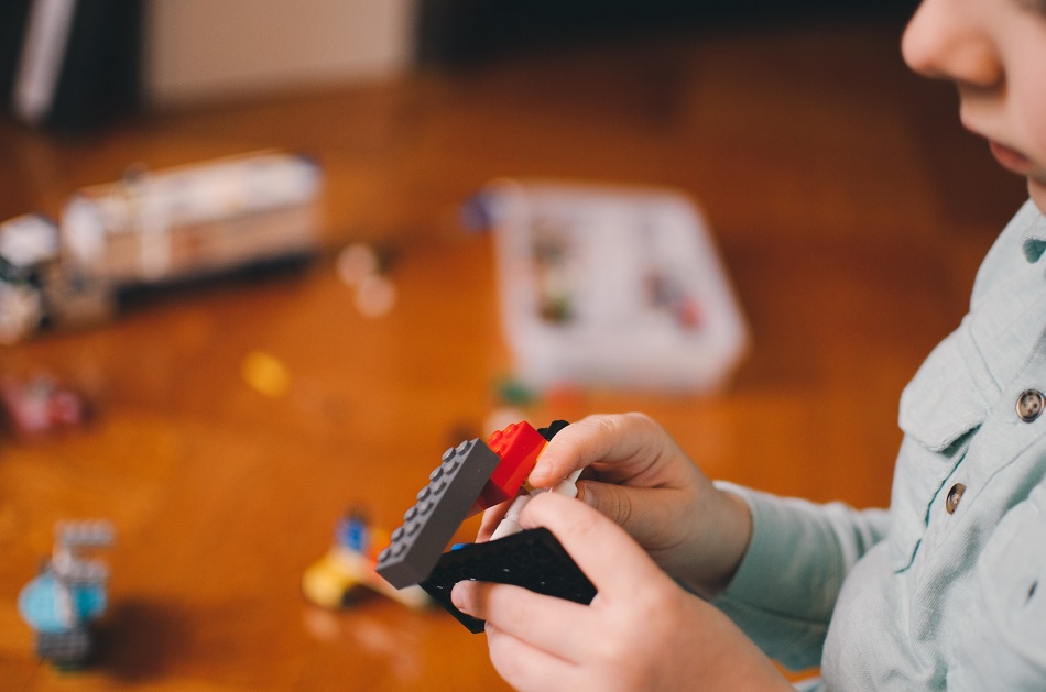 Kid building with Lego blocks