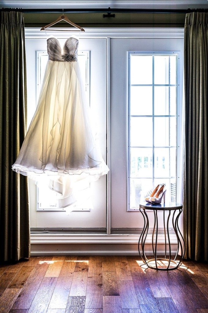 Wedding dress handing on curtain rail