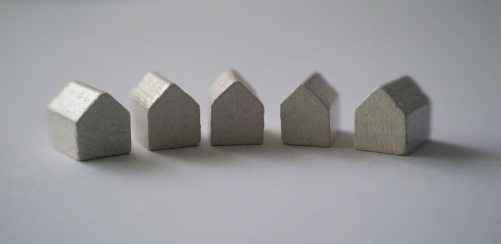 Five small grey model houses