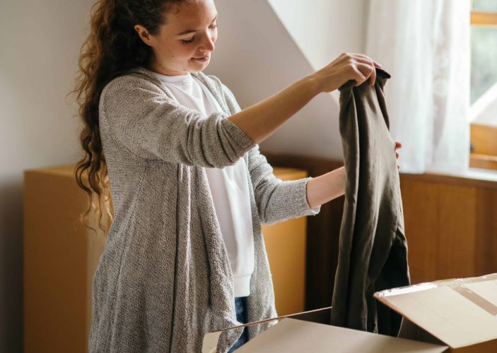 student unpacking her clothes