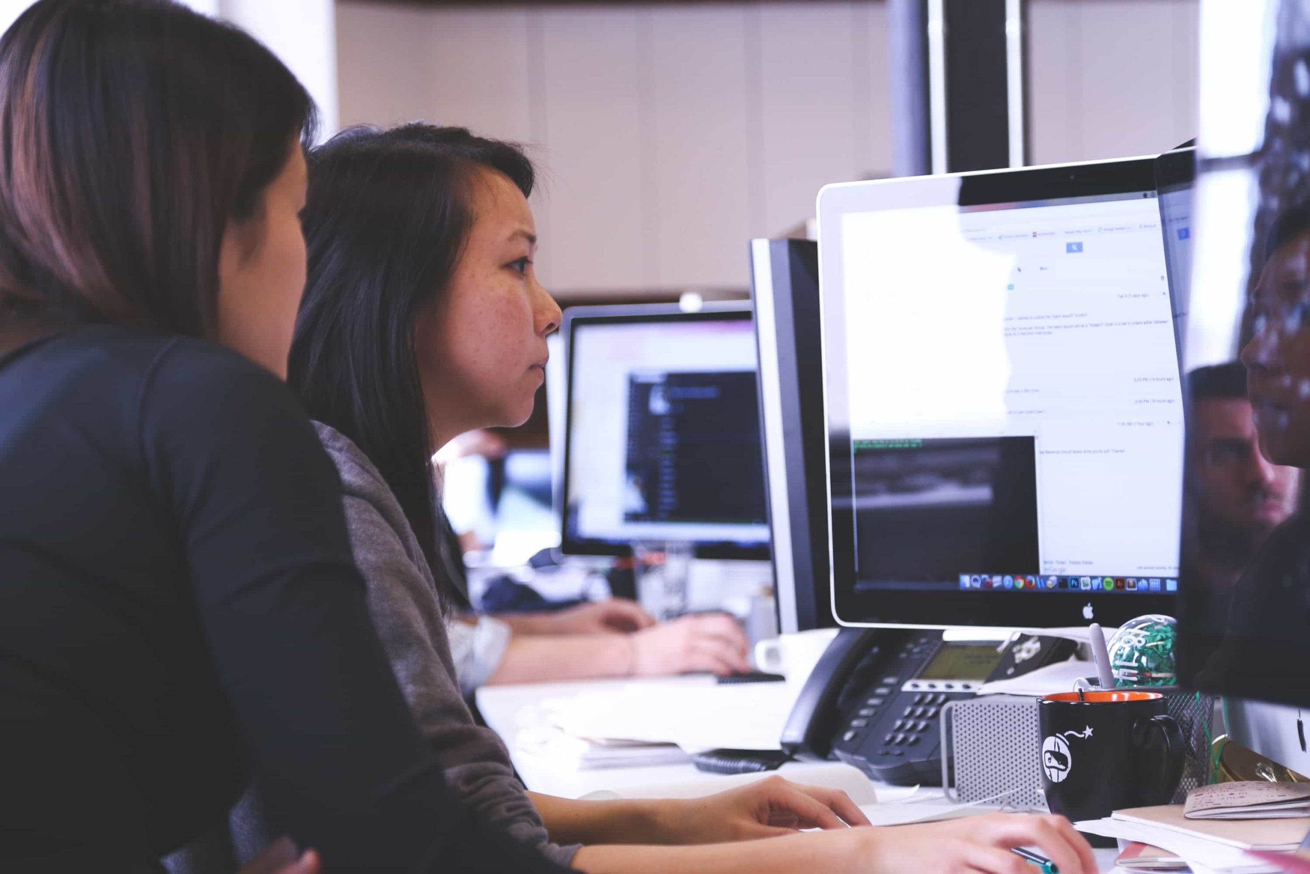 Two people working on a computer