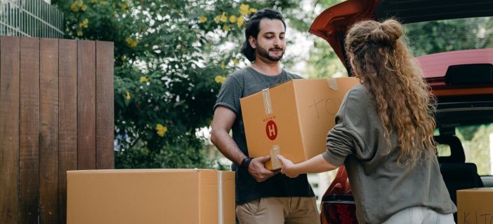 Image of people exchanging a cardboard box