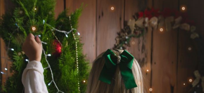 girl putting up christmas descorations